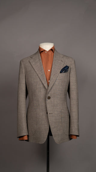 Master tailor measuring custom suit fit at FR Clothiers studio.